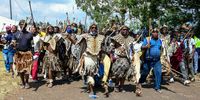 NONGOMA, SOUTH AFRICA - MARCH 18: Zulu warriors approach the gate at the funeral service of King Goodwill Zwelithini KaBhekuzulu on March 18, 2021 in Nongoma, South Africa. It is reported that the late King was accorded a Special Official Funeral Category 1 funeral with military honours. (Photo by Gallo Images/Darren Stewart)