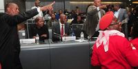 ANC members gesture at EFF members during a singing standoff after the DA’s Tania Campbell was elected Ekurhuleni mayor. (Photo:Leon Sadiki)