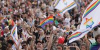 People dance and wave rainbow flags during the annual Gay Pride parade in Tel Aviv, Israel, 08 June 2023. This year Tel Aviv municipality marks 25 years since the first Pride parade in 1998 and expects hundreds of thousands to take part in the Pride events.  EPA-EFE/ABIR SULTAN