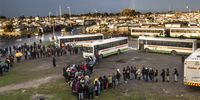 Golden Arrow buses stopped  alongside the N2  at Borchards Quarry ,entrance to Nyanga to transport workers who stood in long lines in the pouring rain from early morning to town and various other places amid ongoing taxi violence on July 21, 2021 in Cape Town, South Africa. It is reported that Golden Arrows Bus Services suspended its bus services in some areas after a Golden Arrow bus driver was shot in the mouth near Borcherd's Quarry as violence continued. (Photo by Gallo Images/Brenton Geach)