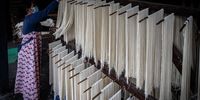 SURABAYA, INDONESIA - JANUARY 12: A worker dries noodles at Marga Mulja factory on January 12, 2022 in Surabaya, Indonesia. Longevity white noodles are a popular dish that is traditionally served in Chinese New Year feasts in Indonesia. Also called "Misoa", the noodles symbolize a wish for longevity, are white in colour and always sold dry. The Marga Mulja factory has been operating since 1948 and produces the widely popular "Mirasa Misoa." (Photo by Robertus Pudyanto/Getty Images)