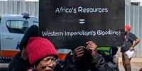 Activists protest outside TotalEnergies’ head office in Rosebank, Johannesburg, against the company’s fossil fuel operations, 5 May 2025. (Photo: Julia Evans)