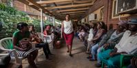 Community Care Giver Nonhlanhla Ngema passes a long queue of patients at Eshowe Gateway Clinic in rural KwaZulu-Natal to pick up ARVs for members of her Community ART Group (CAG). Photo: Médecins Sans Frontières (MSF)/Greg Lomas