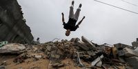 A young Palestinian shows their parkour skills in rubble as they entertain children of the Al Masri family who lost their home after Israeli air strikes during Israel and Islamic Jihad fighting, in Beit Lahiya, northern Gaza Strip, 27 May 2023. The young parkour athletes, most of whom have finished high school and have a job beside their parkour practices, train daily. Parkour, a holistic training discipline that finds its origins in France, combines movements developed from military obstacle training with most suitable actions for the given situation.  EPA-EFE/MOHAMMED SABER