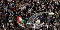 ERBIL, IRAQ - MARCH 07: Pope Francis waves to the crowd as he arrives to conduct mass at the  Franso Hariri Stadium on March 07, 2021 in Erbil, Iraq. Pope Francis arrived in Erbil, the final stop of his historic four-day visit, the first-ever papal visit to Iraq. In his first foreign trip since the start of the pandemic, Pope Francis visited Baghdad, Najaf, Erbil, and the cities of Qaraqosh and Mosul, which were heavily destroyed by ISIS. Although the trip is seen as an act of solidarity, the Vatican has been forced to defend the decision to go ahead with the papal visit amid the ongoing coronavirus pandemic, as Iraq is currently seeing a spike in infection rates as it faces a deadly second wave of the virus. (Photo by Chris McGrath/Getty Images)