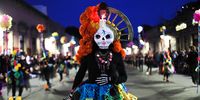 A woman dressed as The Catrina, the grand dame of the dead, participates in a parade in celebration of the Day of the Dead, in the city of Morelia, state of Michoacan, Mexico, 02 November 2021.  EPA-EFE/Ivan Villanueva