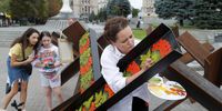 epa10122585 Ukrainian street artist Varvara Logvyn paints national ornaments onto Czech hedgehogs anti-tank obstacles, on Independence Square in Kyiv, Ukraine, 15 August 2022. Varvara plans to paint Czech hedgehogs anti-tank obstacles there in colors of the national flags of countries that help Ukraine to resist the Russian invasion and to paint them with Ukrainian National ornaments. Russian troops on 24 February entered Ukrainian territory, starting a conflict that has provoked destruction and a humanitarian crisis.  EPA-EFE/SERGEY DOLZHENKO