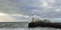 Watching the powerful swells in False Bay pound Kalk Bay Harbour. Photographer: Rens Rezelman