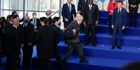 ROME, ITALY - OCTOBER 30: British Prime Minister Boris Johnson, center, is helped up the stage as he arrives late for the group photo if world leaders at the La Nuvola conference center for the G20 summit on October 30, 2021 in Rome, Italy. The G20 (or Group of Twenty) is an intergovernmental forum comprising 19 countries plus the European Union.  It was founded in 1999 in response to several world economic crises. Italy currently holds the Presidency of the G20 and this year's summit will focus on three broad, interconnected pillars of action: People, Planet, Prosperity.  (Photo by Kirsty Wigglesworth - Pool/Getty Images)