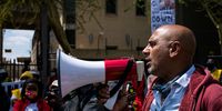 Rehad Desai from Climate Justice Coalition addresses crowd gathered outside DMRE building in Tshwane. (Photo: Julia Evans)
