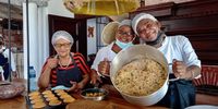 Moms Auguste Pereira and Albertina Joaquim take a break from kitchen duties, with aunt, Célia Cabral. (Photo: Wanda Hennig)<br>