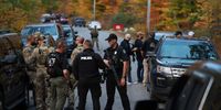 BOWDOIN, MAINE - OCTOBER 26: Law enforcement officials gather in the road leading to the home of the suspect being sought in connection with two mass shootings on October 26, 2023 in Bowdoin, Maine. Police are searching for U.S. Army Reservist Robert Card, 40, who is wanted in the shooting deaths of 18 people at a bowling alley and a bar last night in nearby Lewiston. At least 13 others were wounded in the rampage. (Photo by Joe Raedle/Getty Images)