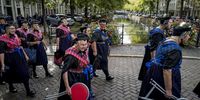 Staphorst women in traditional costumes, carry chairs as theyarrive in The Hague for Budget Day or Prince's Day in the Hague, the Netherlands, 19 September 2023. The Budget Day, also called Prince's Day or Prinsjesdag, falls traditionally on the third Tuesday in September, and serves as the occasion when the government reveals its upcoming year's plans. The Dutch monarch delivers a Speech from the Throne, marking the official commencement of the parliamentary year.  EPA-EFE/EMIEL MUIJDERMAN