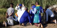 Church members of uKukhanya kuka Jehova Church in Mngadi Katlehong pray before their baptism service at the Klipriver bridge in Ekurhuleni of 07 March 2023. The baptism is part of the Easter weekend service and members are baptised in the Klip River. The old Vereeniging road is nearby and when the prayers started there was a break in traffic. There was absolute silence except for the hum of the prayers in the early morning light.  Photo: Felix Dlangamandla