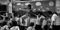 WASHINGTON, DC - MAY 24, 2013: U.S. first lady Michelle Obama dances with pre-kindergarten students while she visits the Savoy School May 24, 2013 in Washington, DC. The Savoy School, once one of the lowest performing schools in the District of Columbia, has shown significant signs of improvement since being designated as one of eight schools selected last year for the Turnaround Arts Initiative by the President's Committee on the Arts and the Humanities. (Photo by Win McNamee/Getty Images)