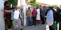 Joanie Fredericks speaks to community members from her home in Mitchell's Plain, Cape Town. (Photo: Daniel Steyn)