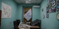 Unbowed, staff have vowed to rebuild after the missile strikes. Here, next to a map of Far South, a flag of Ukraine’s National Antarctic Scientific Centre is held above a fallen monitor and office chaos. (Photo: Aleksandr Zakletsky, Yulia Kryvytska)
