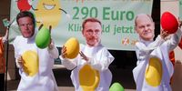 Attac activists wear masks showing the faces of (L-R) German Minister for Economy and Climate Robert Habeck, German Chancellor Olaf Scholz, and German Finance Minister Christian Lindner and hold stylized eggs in front of the Social Democratic Party (SPD) headquarters as they protest in Berlin, Germany, 06 May 2024. The banner reads 'Stop the egg dance, 290 EUR climate money now.' Members of the protest organization Attac protested in front of the Social Democrats' headquarters against the delayed release of the so-called 'Klimageld' (climate money).   EPA-EFE/CLEMENS BILAN