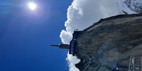 Stepping into the void in the glass cubicle at 3842 metres height on Aiguille du midi, Chamonix Mont Blanc. Photographer: Sarena Baxter