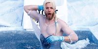 MELBOURNE, AUSTRALIA - JUNE 13: Hamish Blake, Australian comedian, goes down the slide for Big FightMND Freeze 8, during the round 13 AFL match between the Collingwood Magpies and the Melbourne Demons at Melbourne Cricket Ground on June 13, 2022 in Melbourne, Australia. (Photo by Darrian Traynor/Getty Images)
