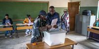 An IEC official help a lady to cast her vote for the parliamentary elections at a polling station in Koro-Koro, on October 7, 2022.<br>Photo: Shiraaz Mohamed.