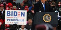 LANSING, MICHIGAN - OCTOBER 27: A derogatory sign against Democratic nominee Joe Biden is held up as U.S. President Donald Trump addresses thousands of supporters during a campaign rally at Capital Region International Airport October 27, 2020 in Lansing, Michigan. With one week until Election Day, Trump is campaigning in Michigan, a state he won in 2016 by less than 11,000 votes, the narrowest margin of victory in the state's presidential election history.  (Photo by Chip Somodevilla/Getty Images)