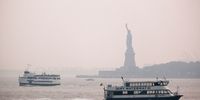 The Statue of Liberty sits behind a cloud of haze on July 20, 2021 in New York City. According to data from the National Oceanic and Atmospheric Administration, wildfire smoke from the west has arrived in the tri-state area creating decreased visibility and a yellowish haze in many areas. (Photo by Spencer Platt/Getty Images)
