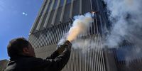 A protester fires fireworks at the Bank Med building during a protest organized by Depositors' Outcry, a group campaigning for the rights of depositors, in Beirut, Lebanon, 19 January 2024. Bank customers gathered outside Lebanon's Central Bank to protest against the unjust circulars to depositors and to demand the imposition of a specific time schedule to return all funds to depositors under the title 'Enough injustice to depositors'.  EPA-EFE/WAEL HAMZEH