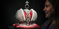 General Director of Jewellery Group Alrosa Irina Morozovskaya smiles next to the Great Imperial Crown created by craftsmen of Alrosa during a press preview of the exhibition 'Notes of a Jeweller. A Diamond History' at the State Historical Museum in Moscow, Russia, 03 October 2023. The exhibition presents works of jewellery art of the Russian Empire and works of modern jewellery masters. The show will run from 04 October to 15 January 2024.  EPA-EFE/YURI KOCHETKOV