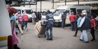 A porter pushes a trolley filled with luggage at Johannesburg’s Wanderers long distance taxi rank on 17 December 2020. (Photo: Shiraaz Mohamed)