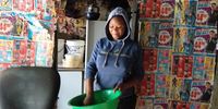 Gweva Honose's daughter Siviwe Arosi wipes a basin she has used to wash dishes. Photo: Bheki Simelane