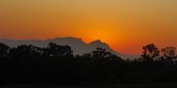 Evening's glow behind Devil's Peak and Table Mountain. Photographer: Brian Barnes.