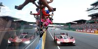 The No.51 Ferrari AF Corse Ferrari 499P of Alessandro Pier Guidi, James Calado and Antonio Giovinazzi passes a celebrating Ferrari team after winning the 100th 24 Hours of Le Mans at on 11 June 2023 in Le Mans, France. (Photo: Clive Rose/Getty Images)