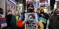 TOKYO, JAPAN - FEBRUARY 24: A man holds a placard during a protest in front of the Shibuya Station on February 24, 2022 in Tokyo, Japan.  Japan’s Prime Minister, Fumio Kishida, has strongly condemned Russia's attack on Ukraine and stated that it undermines the foundation of the international order. Japan has also joined other nations in imposing economic sanctions on Russia. (Photo by Takashi Aoyama/Getty Images)
