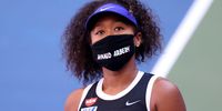 Naomi Osaka wears a mask with the name Ahmaud Arbery stencilled on it during the 2020 US Open. Arbery, an unarmed 25-year-old African-American, had been fatally shot while jogging in Glynn County, Georgia. (Photo by Al Bello/Getty Images)