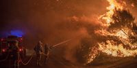Several forest firefighters carry out extinction work in a forest fire in Cualedro, Ourense (Galicia, northwestern Spain). Summer of 2020 has become again a distressing summer for Ourense, where fires repeat cyclically in one of the provinces of Europe most affected by the flames. Photo by Brais Lorenzo Couto