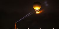 A general view of Eiffel Tower's spotlight shining towards the Olympic Cauldron in the sky after being lit by Torch bearers French Athlete Marie-Jose Perec and French Judoka Teddy Riner (not pictured) during the opening ceremony of the Olympic Games Paris 2024 on July 26, 2024 in Paris, France. (Photo by Julian Finney/Getty Images)