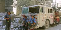 394277 14: New York City firefighters take a rest at the World Trade Center after two hijacked planes crashed into the Twin Towers September 11, 2001 in New York. (Photo by Ron Agam/Getty Images)