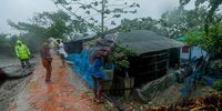 People are caught in strong wind in the aftermath of tropical cyclone Remal in Shyamnagar Upazila, Satkhira District, Bangladesh, 27 May 2024. Bangladeshi State Minister for Disaster Management and Relief, Md Mohibur Rahman, said that they have taken adequate measures to support the affected people and Remal has already weakened and was gradually reduced to a depression.  EPA-EFE/Abdul Goni