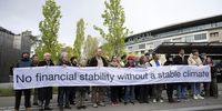 epa11301826 Activists hold a banner reading 'No financial stability without a stable climate' as they protest against fossil investment prior to the 116th Ordinary General Meeting of Shareholders of the Swiss National Bank (SNB), at Bern, Switzerland, 26 April 2024.  EPA-EFE/ANTHONY ANEX