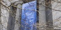 Banner of US President Donald Trump hung from Department of Justice
