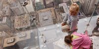 CHICAGO - JULY 01:  Five -year-old  Anna Kane (L) and  four-year-old Sophie Allaway check out the view from the Ledge, a new glass cube that juts out from the 103rd floor Skydeck of the Sears Tower, during a media preview July 1, 2009 in Chicago, Illinois. The 1,353 foot high observatory will open to the public tomorrow.  (Photo by Scott Olson/Getty Images)