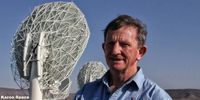 Professor Justin Jonas with the MeerKAT radio telescopes he helped bring into being. Image: Chris Marais<br>