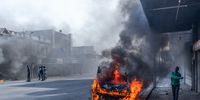 A vehicle burns in a Durban street after violent protests broke out.