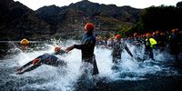 WANAKA, NEW ZEALAND - FEBRUARY 20:  Competitors enter the water to embark on the swim leg during Challenge Wanaka on February 20, 2021 in Wanaka, New Zealand. (Photo by Joe Allison/Getty Images)