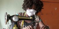 A woman sews masks for protection from the Covid-19 disease in Luanda, Angola. (Photo: EPA-EFE / Ampe Rogerio)