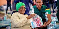 The Gift of the Givers team handing over toiletries to an affected resident Picture: Donna van der Watt