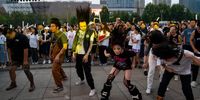 People dance as they listen to a live performance during Rock Home Town Festival in Shijiazhuang, China, on Sunday, Sept. 4, 2023. Local officials in Shijiazhuang, the country's spiritual home for rock music, are eager for the economic boost from concerts. Photographer: Andrea Verdelli/Bloomberg via Getty Images