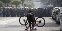epa09039396 A demonstrator places his bicycle in front of riot police during a protest against the military coup, in Yangon, Myanmar, 27 February 2021. Anti-coup demonstrations continued despite intensifying use of force by security forces against protesters after weeks of unrest since the 01 February military coup.  EPA-EFE/LYNN BO BO