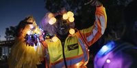 Brixton resident Lucy Msomi volunteers as a marshal to lead the procession safely through the streets, on 6 February 2022. (Photo: James Puttick)